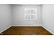 Bedroom featuring hardwood floors, plantation shutters, and neutral paint at 5609 Abbey Grace Ln, Wake Forest, NC 27587