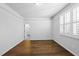 Well-lit bedroom showcasing hardwood floors, crown moulding, and an open doorway at 5609 Abbey Grace Ln, Wake Forest, NC 27587