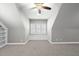 Bright bonus room featuring built-in shelving, carpeted floor, and a ceiling fan at 5609 Abbey Grace Ln, Wake Forest, NC 27587