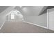 Expansive bonus room showcasing built-in shelving and a ceiling fan at 5609 Abbey Grace Ln, Wake Forest, NC 27587
