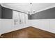 Dining room showcasing hardwood floors, a chandelier, and plantation shutters at 5609 Abbey Grace Ln, Wake Forest, NC 27587