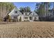 Traditional home with a white painted brick exterior, manicured landscaping, and dark shutters at 5609 Abbey Grace Ln, Wake Forest, NC 27587
