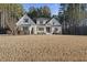 Stunning white brick two-story home with a well-manicured lawn and a welcoming front porch at 5609 Abbey Grace Ln, Wake Forest, NC 27587