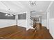 Bright foyer featuring hardwood floors, stairs to the second floor, and gray walls at 5609 Abbey Grace Ln, Wake Forest, NC 27587
