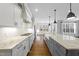 Bright kitchen features granite counters, white cabinetry and stainless steel appliances at 5609 Abbey Grace Ln, Wake Forest, NC 27587