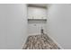 Well-lit laundry room featuring cabinetry, sleek tiling, and modern appliance connections at 5609 Abbey Grace Ln, Wake Forest, NC 27587