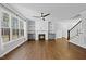 Cozy living room with hardwood floors, a fireplace flanked by built-in shelving, and large windows for natural light at 5609 Abbey Grace Ln, Wake Forest, NC 27587