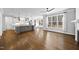 Spacious living space featuring hardwood floors, a large kitchen island, stainless appliances, and an abundance of natural light at 5609 Abbey Grace Ln, Wake Forest, NC 27587