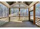Screened in porch with wood ceiling and patterned wood railing overlooking woods at 5609 Abbey Grace Ln, Wake Forest, NC 27587