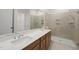 This bathroom boasts a luxurious walk-in shower, double sink vanity, and neutral tile at 616 Long Lake Dr, Fuquay Varina, NC 27526