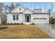 Charming white two-story home featuring a covered porch and attached two-car garage at 616 Long Lake Dr, Fuquay Varina, NC 27526