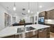 Open kitchen featuring stainless steel appliances, island sink, and view to the living room and outdoor patio at 616 Long Lake Dr, Fuquay Varina, NC 27526