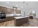 Gourmet kitchen with stainless-steel appliances, large island, and contemporary pendant lighting at 616 Long Lake Dr, Fuquay Varina, NC 27526