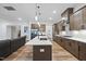 Sleek kitchen with large island, stainless steel appliances, and pendant lights, perfect for entertaining at 616 Long Lake Dr, Fuquay Varina, NC 27526