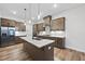 Modern kitchen with stainless appliances, large center island with sink, and ample counter space at 616 Long Lake Dr, Fuquay Varina, NC 27526