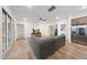 Spacious living room with natural light, hardwood floors, and a modern ceiling fan at 616 Long Lake Dr, Fuquay Varina, NC 27526