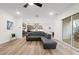 Open concept living room with hardwood floors flowing into the kitchen with stainless appliances at 616 Long Lake Dr, Fuquay Varina, NC 27526