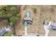 Aerial view of a home with a well-maintained yard and an above-ground pool, surrounded by mature trees at 64 Old Barn Way, Wendell, NC 27591