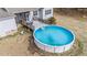 A large above-ground pool and deck area in a spacious backyard, perfect for summer fun and relaxation at 64 Old Barn Way, Wendell, NC 27591