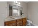 Bathroom featuring double sinks, wood cabinets, and a large mirror at 64 Old Barn Way, Wendell, NC 27591