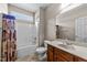 Bright bathroom featuring a shower-tub combo, neutral walls, and a vanity with ample counter space at 64 Old Barn Way, Wendell, NC 27591