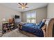 Comfortable bedroom with a ceiling fan, dresser, and a window providing natural light and outdoor views at 64 Old Barn Way, Wendell, NC 27591
