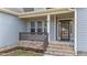 Charming front porch with brick accents, leading to an inviting entryway, offering curb appeal at 64 Old Barn Way, Wendell, NC 27591