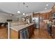 Spacious kitchen with a central island, stainless steel appliances, and hardwood floors throughout at 64 Old Barn Way, Wendell, NC 27591
