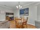 Dining room with wood table, chairs, and floor; overhead lighting; and artwork on the wall at 7246 Aquinas Avenue Ave, Raleigh, NC 27617