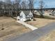 Aerial view of the home, showing the front yard, three car garage, and surrounding neighborhood at 76 Freewill Pl, Raleigh, NC 27603