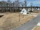Aerial view of the home, showing the large backyard, long driveway, and three-car garage at 76 Freewill Pl, Raleigh, NC 27603