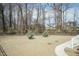 View of the home's fenced backyard with two small trees and a portion of the concrete patio at 76 Freewill Pl, Raleigh, NC 27603
