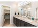 Bright bathroom features double sinks with granite countertops and a walk-in closet at 76 Freewill Pl, Raleigh, NC 27603