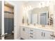 Bright bathroom featuring double sinks with white cabinetry and tile flooring at 76 Freewill Pl, Raleigh, NC 27603