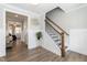 Elegant hallway features hardwood floors, wainscoting, and an attractive staircase at 76 Freewill Pl, Raleigh, NC 27603
