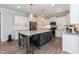 Spacious kitchen showcasing a large island, stainless steel appliances, and white cabinets at 76 Freewill Pl, Raleigh, NC 27603