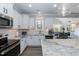 Well-equipped kitchen featuring a large island, modern appliances, and white cabinetry at 76 Freewill Pl, Raleigh, NC 27603
