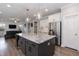 Open concept kitchen featuring a large island and a view of the living room area at 76 Freewill Pl, Raleigh, NC 27603