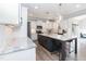 Bright kitchen boasts an island, white cabinets, stainless appliances, and ample counter space at 76 Freewill Pl, Raleigh, NC 27603