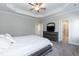 Spacious main bedroom with a tray ceiling, ceiling fan, and carpet flooring at 76 Freewill Pl, Raleigh, NC 27603
