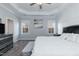 Main bedroom featuring a large comfortable bed, ceiling fan, and two windows at 76 Freewill Pl, Raleigh, NC 27603