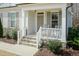 Inviting front porch with seating and manicured landscaping, creating a warm welcome at 76 Freewill Pl, Raleigh, NC 27603