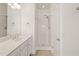 Bright bathroom features a shower and tub, with a sink vanity and updated fixtures at 7732 Acc Blvd, Raleigh, NC 27617