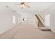 Spacious living room with neutral carpet, staircase, and natural light streaming in from multiple windows at 7732 Acc Blvd, Raleigh, NC 27617