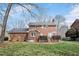 A beautiful backyard with a well-manicured lawn, lovely deck, and charming brick facade at 810 Warwick Ct, Burlington, NC 27215