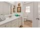 Bright bathroom features a single vanity with a framed mirror and artistic accents on the wall and through the open door at 810 Warwick Ct, Burlington, NC 27215