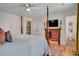 Comfortable bedroom featuring a four-poster bed, mounted TV and a vintage American flag as decor above the fireplace at 810 Warwick Ct, Burlington, NC 27215