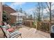 Wooden deck set up with metal outdoor seating including a table and a set of chairs and greenery around the edges at 810 Warwick Ct, Burlington, NC 27215