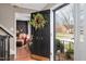 Inviting front entrance featuring a black door, a decorative wreath, and a glimpse of the living room at 810 Warwick Ct, Burlington, NC 27215