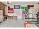 Spacious garage with a variety of unique flags hanging above the doors and exercise equipment including a trampoline at 810 Warwick Ct, Burlington, NC 27215